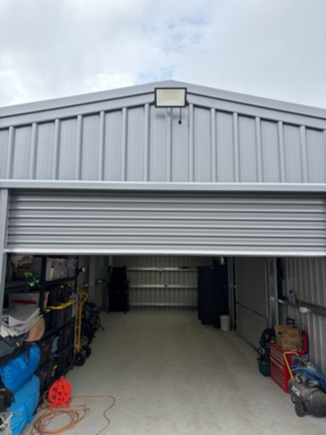 New grey Colorbond garage with a roller door