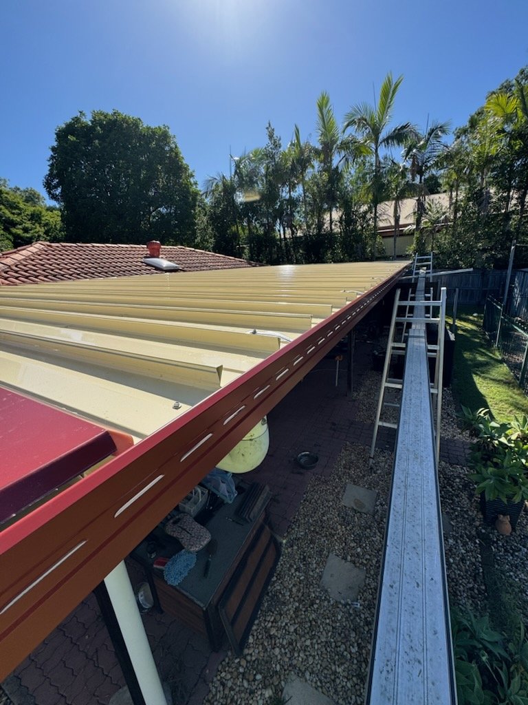 New Colorbond gutter and downpipe installed along a patio roof