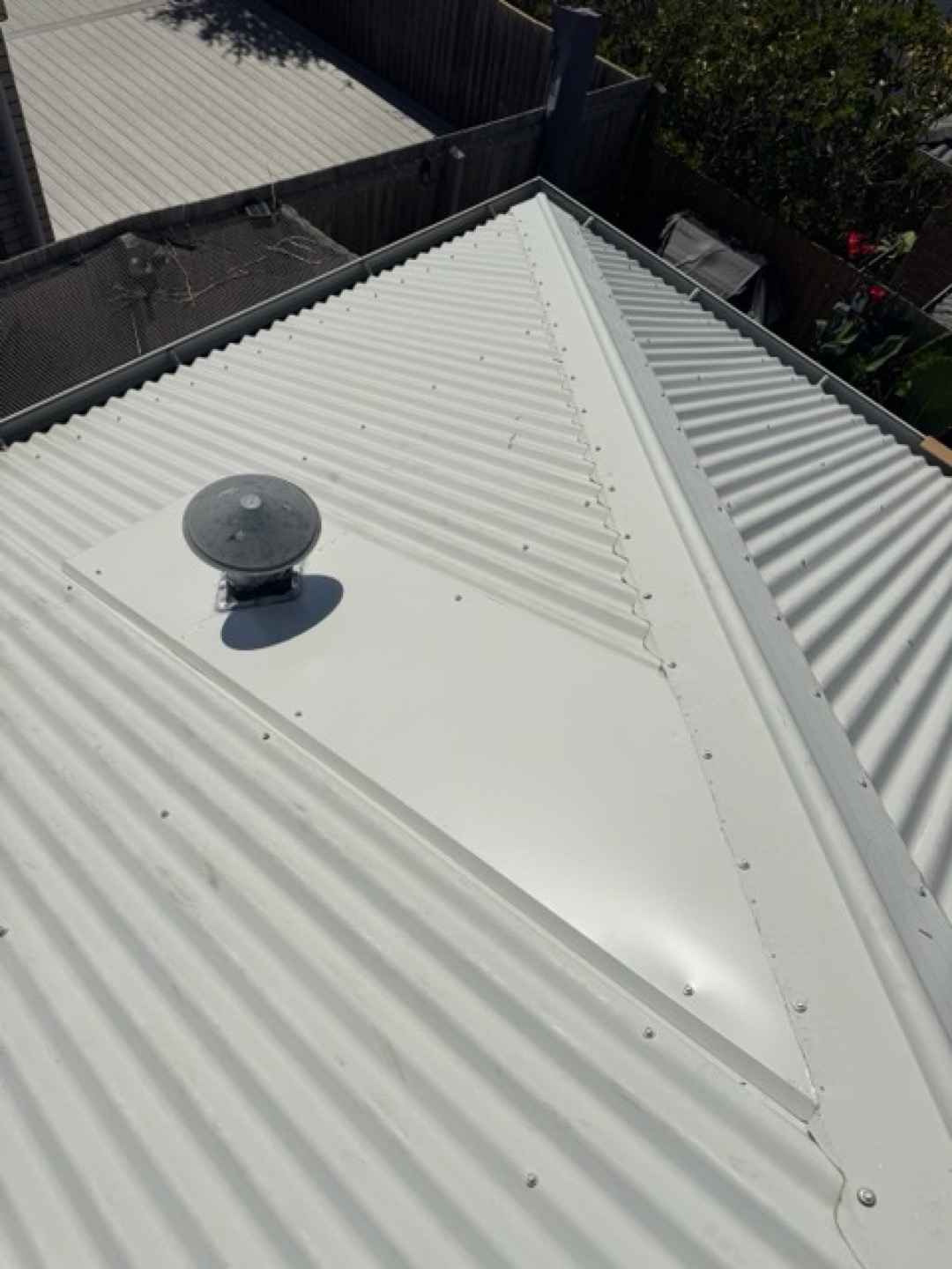 Ridge capping and vent on a metal roof