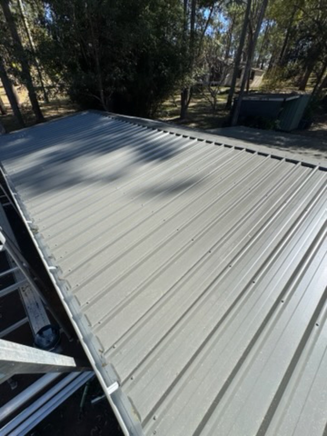 Grey corrugated metal roof on a bushland home