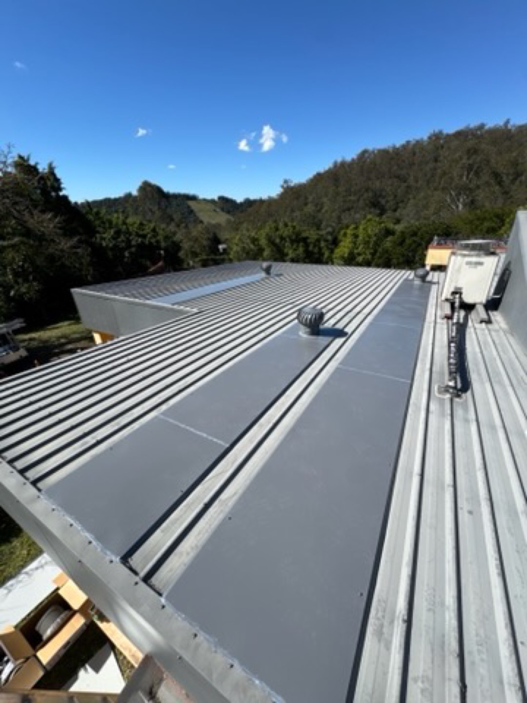 Whirlybird vent on a grey metal roof