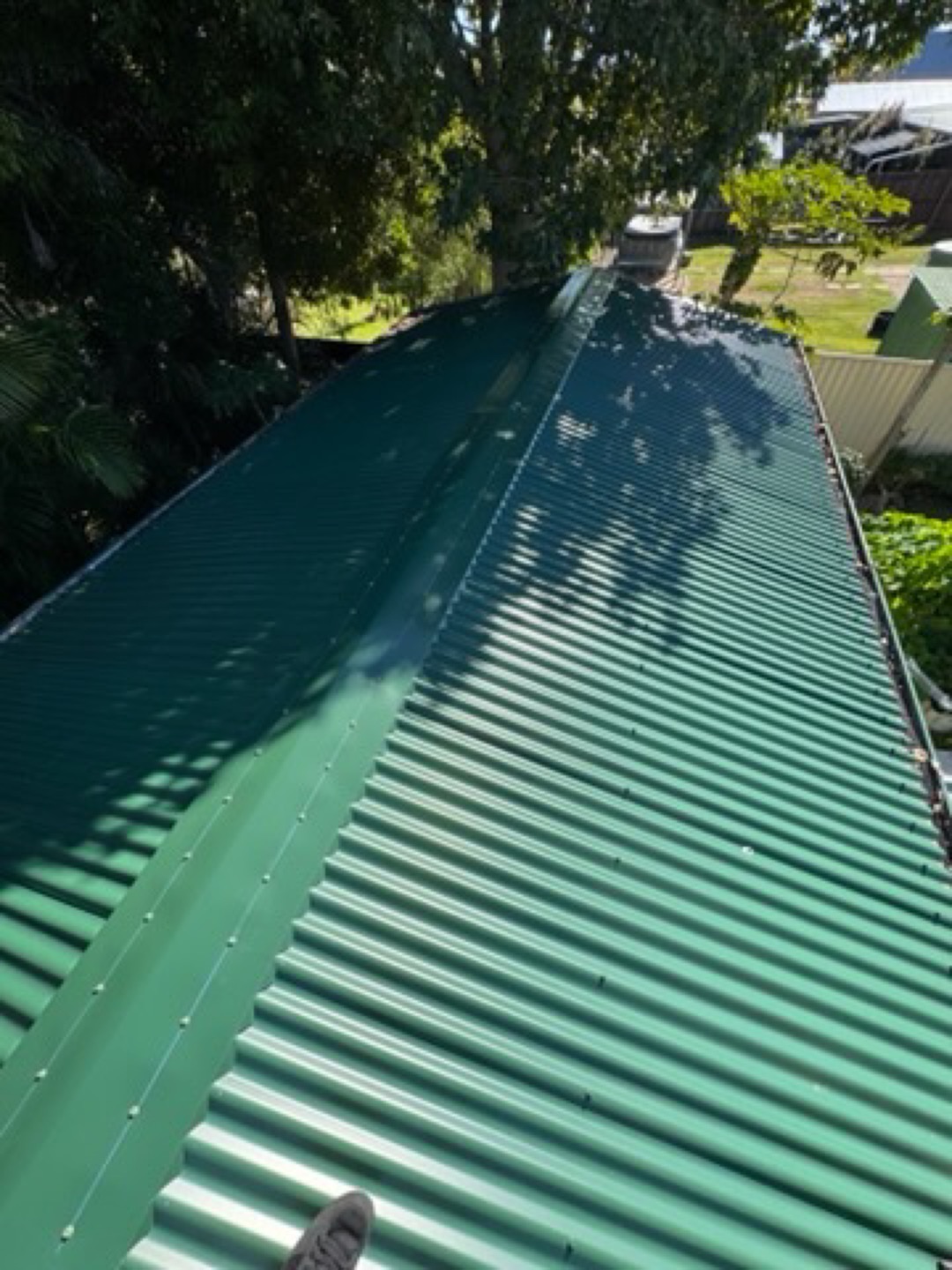 Ridge capping on a dark green corrugated roof