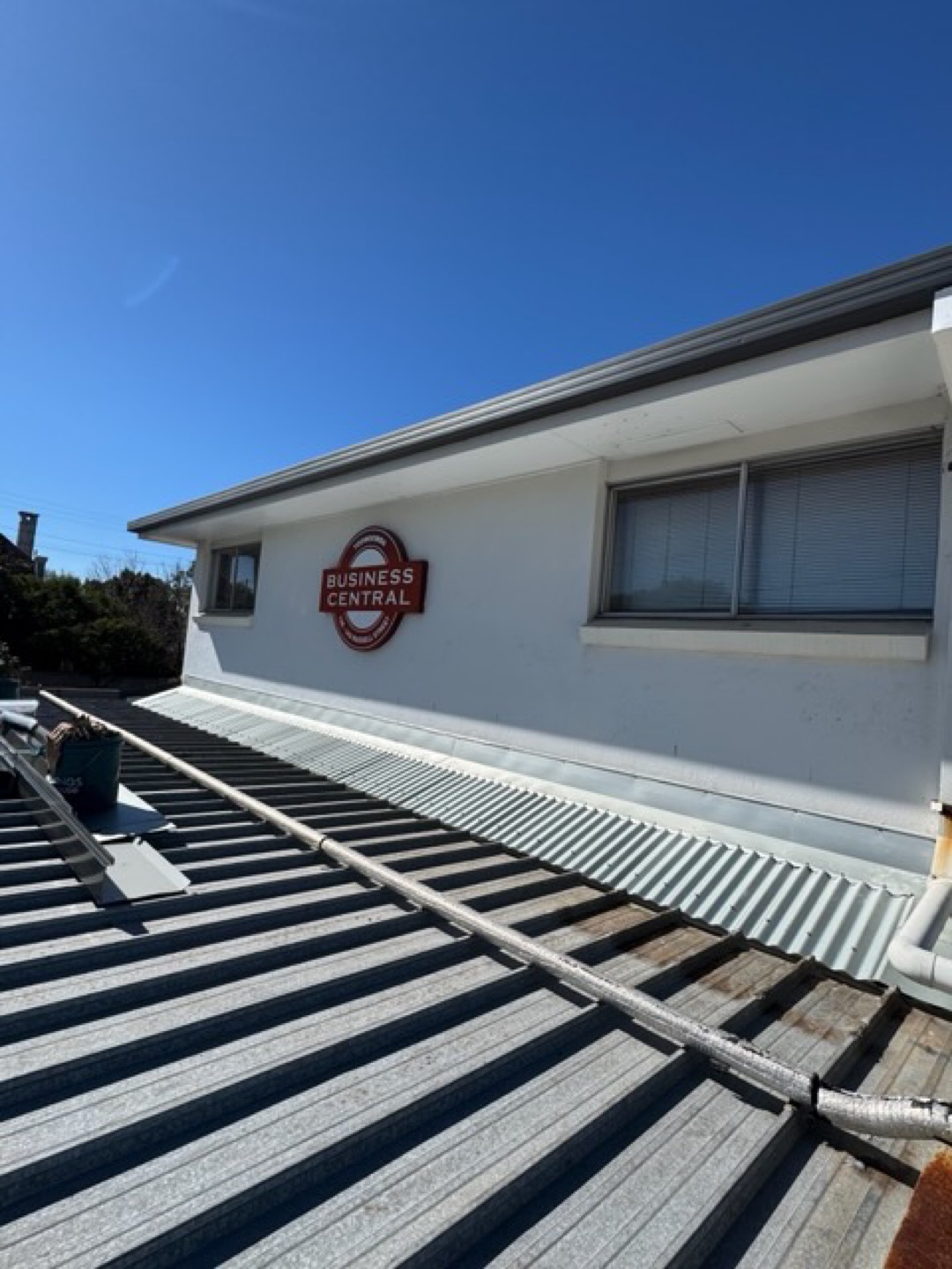 Apron flashing where a metal roof meets a rendered wall