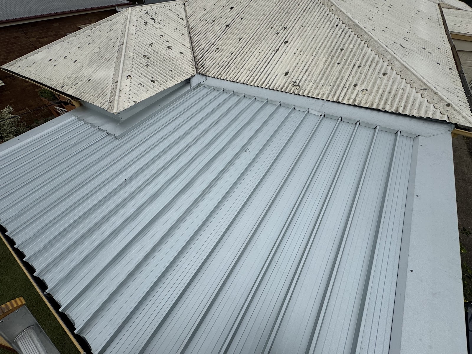 New metal roof meeting an older roof at the junction